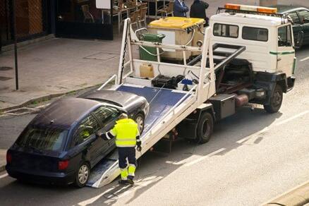 SUV being towed by a truck